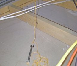 Crescent Wrench and String on the Basement Ceiling